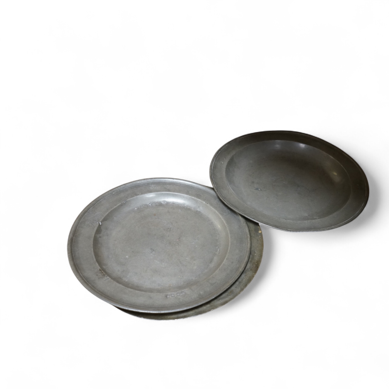 Three Pewter chargers, a large dish and a plate, c.1800, largest dish 42cm diameter (5)